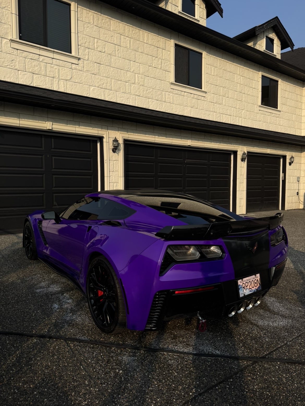 Purple Corvette Z06 rear quarter gleaming after paint correction